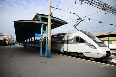 ZAPORIZHIA, UKRAINE - MARCH 24, 2019: High speed train at the railway station at sunset in Europe. Modern intercity train on railway platform.のeditorial素材