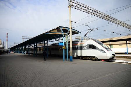 ZAPORIZHIA, UKRAINE - MARCH 24, 2019: High speed train at the railway station at sunset in Europe. Modern intercity train on railway platform.のeditorial素材