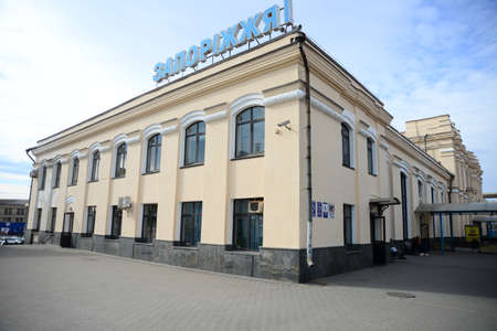 ZAPORIZHIA, UKRAINE - MARCH 24, 2019: Architecture of Zaporizhzhia I train station people waiting with luggage in historic Ukrainian Cityのeditorial素材