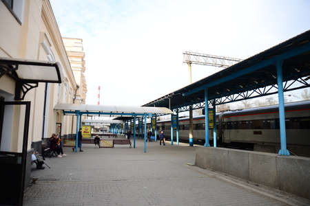 ZAPORIZHIA, UKRAINE - MARCH 24, 2019: Architecture of Zaporizhzhia I train station people waiting with luggage in historic Ukrainian Cityのeditorial素材
