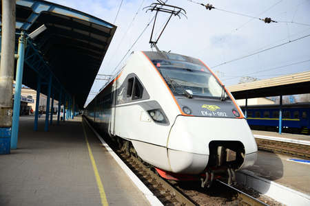 ZAPORIZHIA, UKRAINE - MARCH 24, 2019: High speed train at the railway station at sunset in Europe. Modern intercity train on railway platform.のeditorial素材