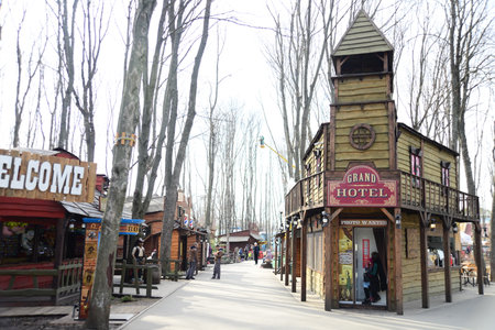 UKRAINE, KHARKIV - MARCH 29, 2019: Entrance to Gorky Central Park of Culture and Leisure. Wooden houses for entertaining attractions, enjoying active games and funny attractionsのeditorial素材