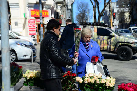 KYIV, UKRAINE - APRIL 5, 2019: People hangout and looking for flower vendors on Volodymyrska Street in front of the Golden Gateのeditorial素材