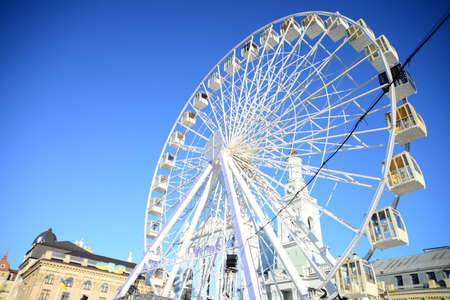 KYIV, UKRAINE - APRIL 5, 2019: Ferris wheel and the complex of buildings of the former Greek monastery of St. Catherine on Kontraktova Squareのeditorial素材