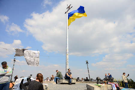 LVIV, UKRAINE - APRIL 17, 2019: People tourists at the top of High Castle Hill, Ukrainian city old town mountain peak on sunny summer day cityscape. Lviv city seen from mount on High Castle Hillのeditorial素材