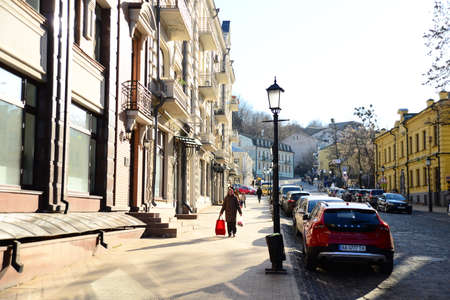 KYIV, UKRAINE - APRIL 5, 2019: Ferris wheel and the complex of buildings of the former Greek monastery of St. Catherine on Kontraktova Squareのeditorial素材