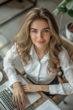 From above Business woman smiling while working with laptop in office. businesswoman conceptの素材