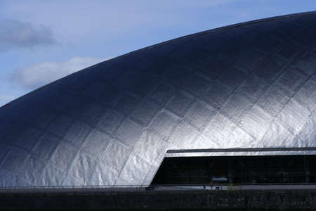The titanium cladding of the Glasgow Science Centre in the sunshineの写真素材