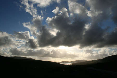 Sculpted clouds over the landscape of South Harris near Luskentyre, Western Isles, Scotland, as sunset approaches.の写真素材