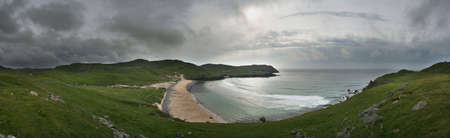 Dalmore Beach on Lewis, Western Isles, Scotland; with the sun trying to break through a milky sky.の写真素材