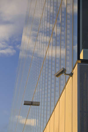 Security cameras against an office building in the evening sunlight