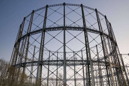 The supporting structure of a gas storage tank against evening sky