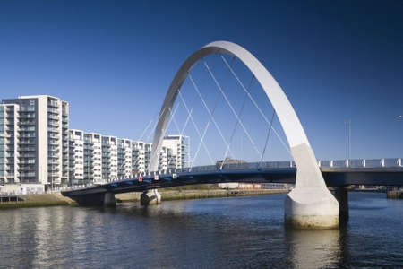 The supporting arch of the Clyde Arc bridge in Glasgow, Scotland, against a blue skyの写真素材