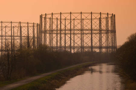 Filtered image of canal and a gas storage tankの写真素材