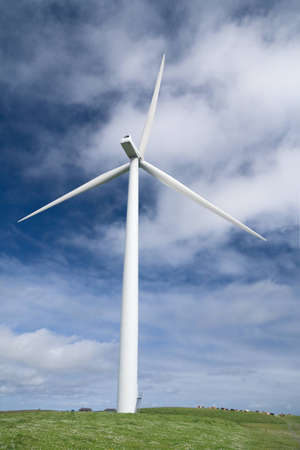 Wind turbine on Orkney against blue sky and clouds