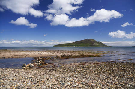 Holy Isle just off an Arran Beach in Scotlandの写真素材