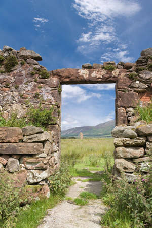 Ruined doorway looking towards neolithic standing stones, Machrie, Scotlandの写真素材