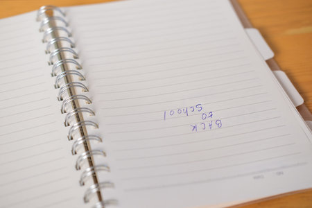 Close-up of a sheet of paper in a school notebook with the words Back to School written in pen....