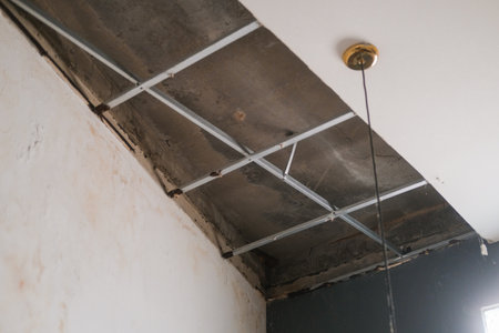 Bottom up view of collapsed plasterboard ceiling, moisture and rust caused a hole in the ceiling. Leak and old house. Need for renovation. Repair of an old house.の写真素材