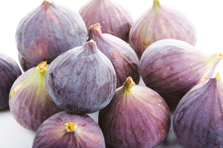 Lots of fresh figs isolated on white background