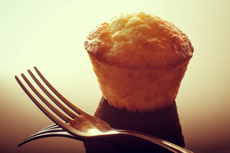 Muffin of cottage cheese dough. Fork in the foreground