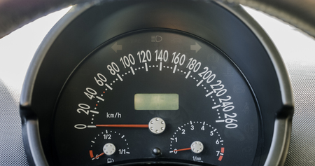 Close up of car dashboard cluster or Instrument panel with speedometer in km'h, rpm gauge, and fuel...