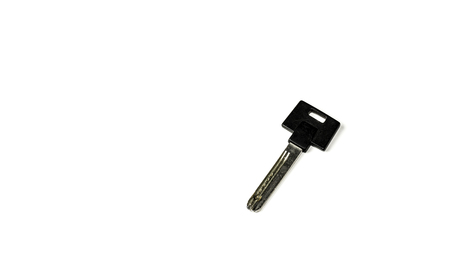 Used modern specialized key for possible different purposes showing wear and tear after long term usage isolated on white. Studio shot. Copy space.の写真素材