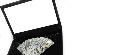 Laptop or notebook with widespread of cash money isolated on white background with clean blank display. Template, mock up.の写真素材