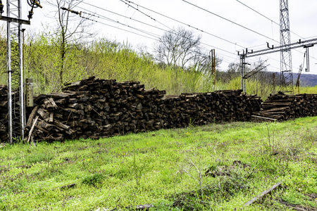 Big piles of old weathered railway wooden sleepers - Out of use wooden sleeper used for railway trackの写真素材
