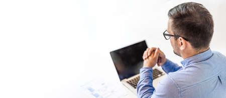 Young smiling cheerful businessman in office on video conference call