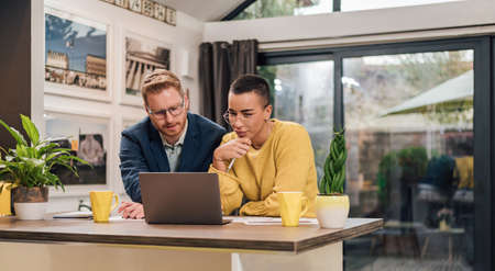 Happy mixed races couple shopping online young people purchasing web shop, entrepreneur pays using...