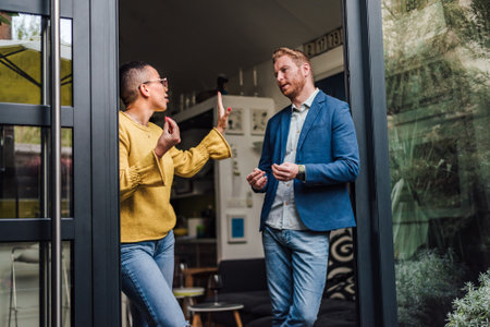 Boyfriend and girlfriend are arguing at home. Man and woman are having fight misunderstanding or quarrel. Couple having problems in relationship. Money problems in marriage or relationship.の写真素材