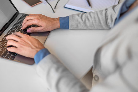 Close up shot of woman hands working on laptop computer. Businesswoman entrepreneur in office focus...