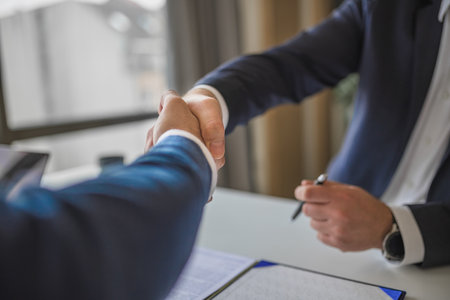 Picture of two businessman, approving of the terms of the contract they signed.