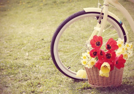 Retro photo  Bike with flowers in a basketの写真素材