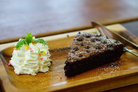 brownies cake with creamy on wood plateの写真素材