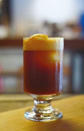 Ice black coffee and lemon mix in glass on foreground and soft blur for backgroundの写真素材