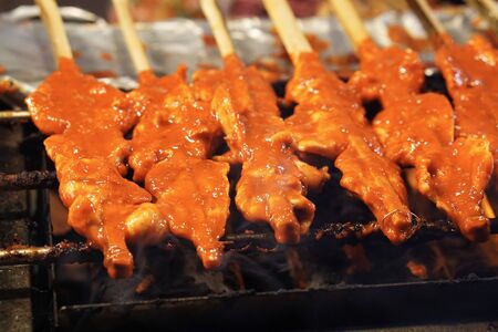 Roll of grilled chicken with coconut milk, Chicken in bamboo stick is charcoal grill, Thai food style from southernの写真素材
