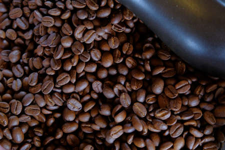 group of roasted coffee beans, light and shadow on roasted coffee beans background