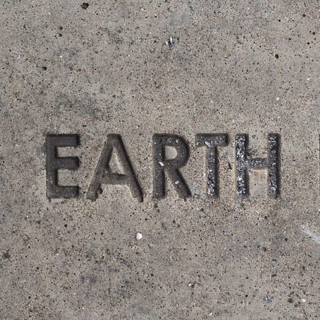 Wording -EARTH-on cnncrete floor background