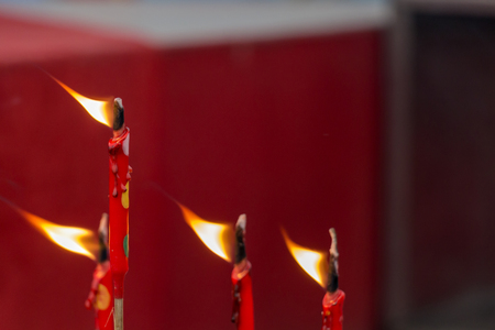 incense burner incense stick in a pot on the spot joss sticks with fire.Burning red candle.の写真素材