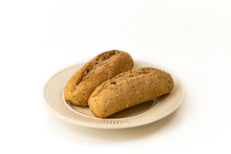 Two baguettes on an off-white plate isolated on a white backgroundの写真素材