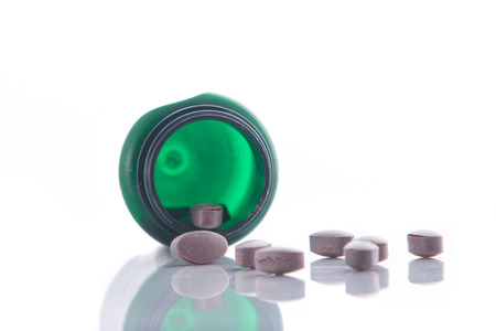 Bottle with vitamin pills isolated on a white backgroundの写真素材