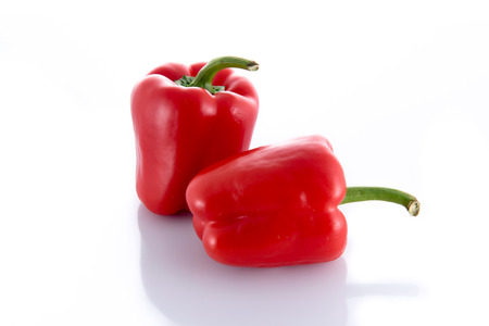 Two red peppers isolated on a white backgroundの写真素材