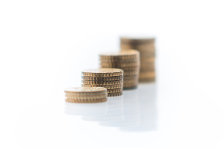 Four heaps of euro coins isolated on a white background
