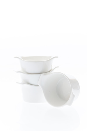 Pile of white porcelain cups isolated on a white backgroundの写真素材