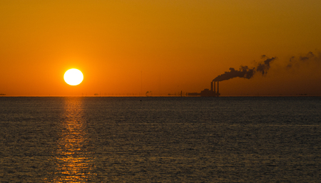 Power plant generating energy in the earily morning with pollutionの写真素材