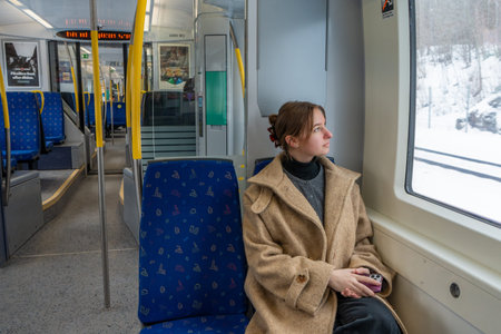 Solo Female Traveler Sitting in Train Looking Through Window.