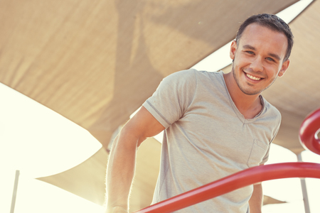 young and handsome man and sport exercise on horizontal bars