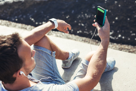 mobile smartphone in man's hands near the seaの写真素材